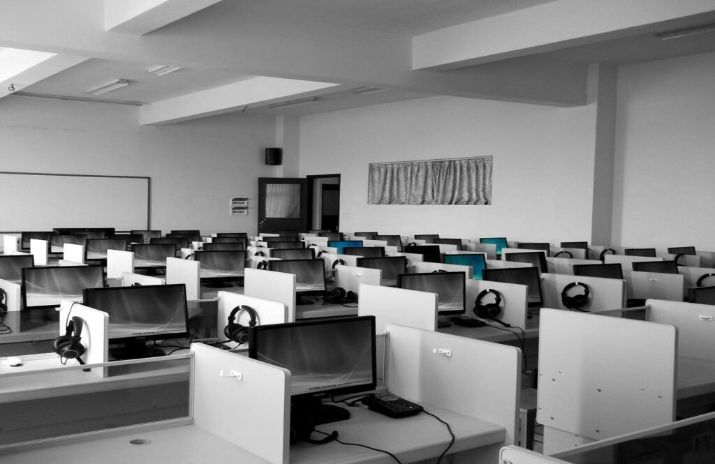 A spacious, empty call center office with rows of desks and computers, ideal for business environments.